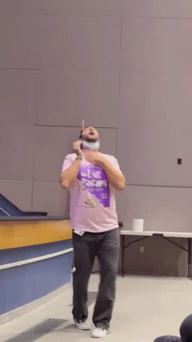 A Man Wearing A Purple Shirt That Says Link Arms GIF