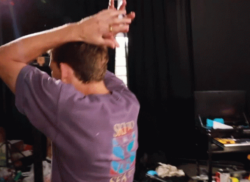 A Man Wearing A Purple Shirt That Says Sky On The Back Of It GIF