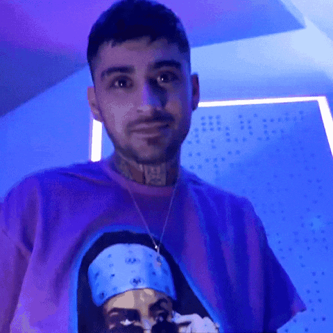 A Man Wearing A Purple Shirt With A Picture On It GIF