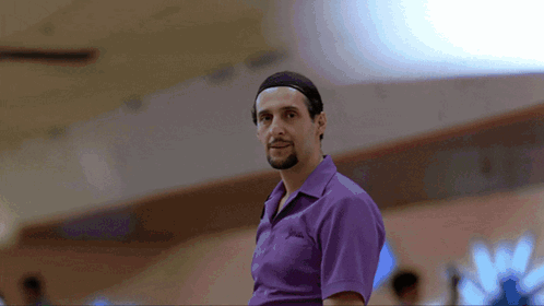 A Man Wearing A Purple Shirt With The Word Columbia On It GIF