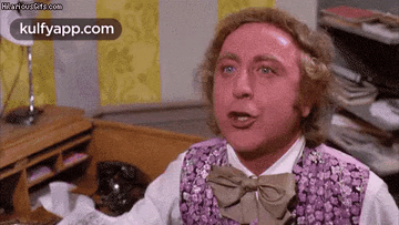 Man In Purple Vest And Bow Tie Sitting At Desk GIF