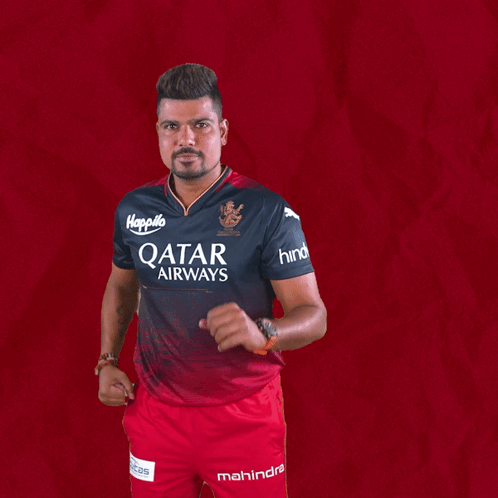 A Man Wearing A Qatar Airways Shirt And Mahindra Shorts GIF