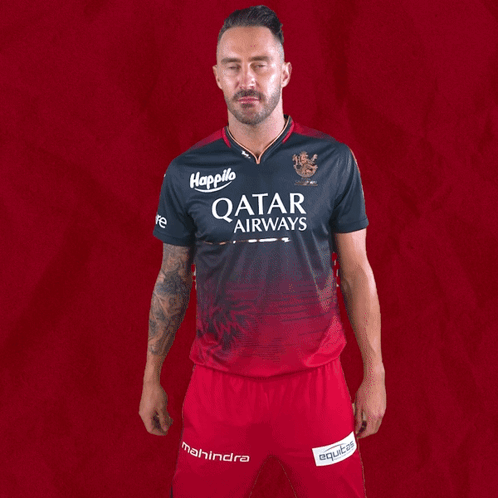 A Man Wearing A Qatar Airways Shirt And Shorts GIF