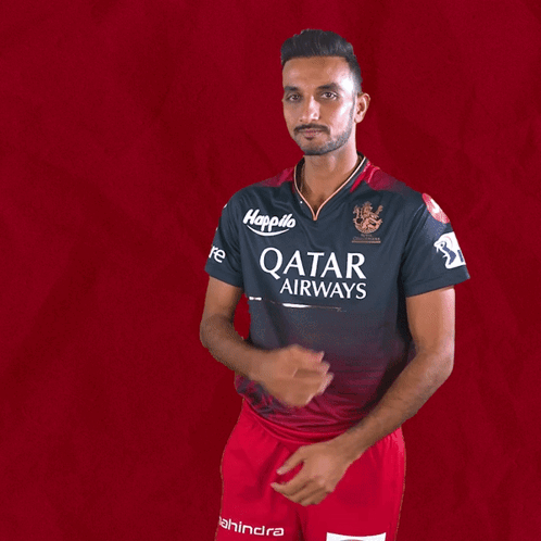 A Man Wearing A Qatar Airways Shirt Holds His Hands Together GIF