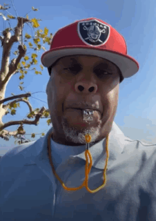 A Man Wearing A Raiders Hat And A Whistle GIF