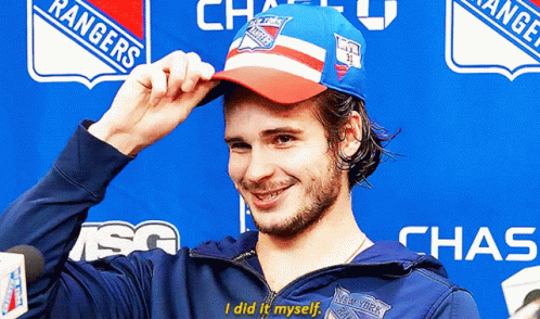 A Man Wearing A Rangers Hat And A Chase Jacket GIF
