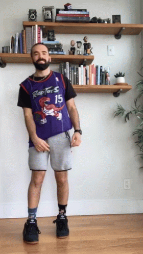 A Man Wearing A Raptors Jersey And Shorts GIF