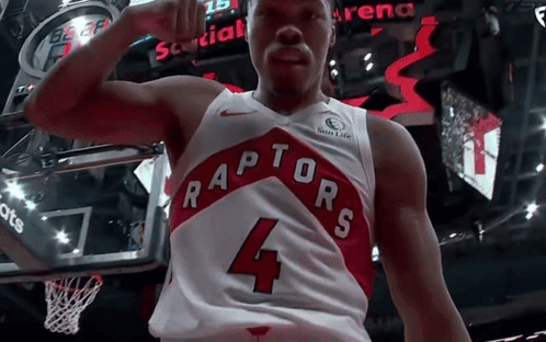 a man wearing a raptors jersey with the number 4