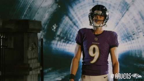 A Man Wearing A Ravens Jersey And Helmet Stands In A Tunnel GIF