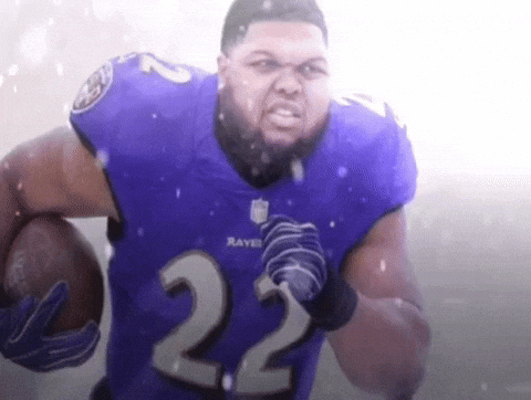 a man wearing a ravens jersey with the number 22 on it