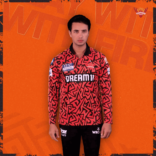 A Man Wearing A Red And Black Jersey That Says Dream On It GIF