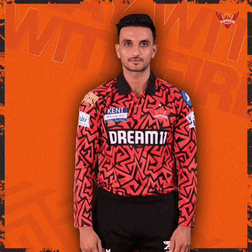 a man wearing a red and black jersey that says dream11 on it