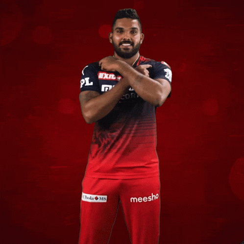 A Man Wearing A Red And Black Shirt That Says Exide Muthoot Fincorp On It GIF