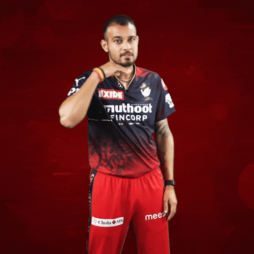 a man wearing a red and black shirt that says exide on it