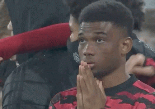 a man wearing a red and black shirt with the number 19 on the front