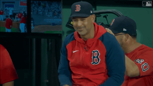 A Man Wearing A Red And Blue Jacket With A B On It GIF