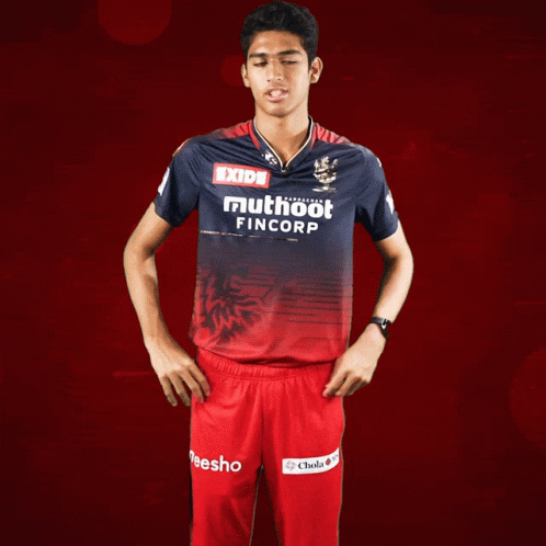 A Man Wearing A Red And Blue Shirt That Says Exide Muthoot Fincorp GIF