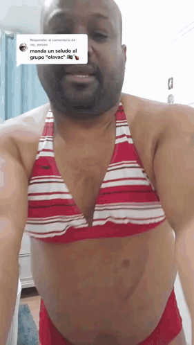 a man wearing a red and white bikini top