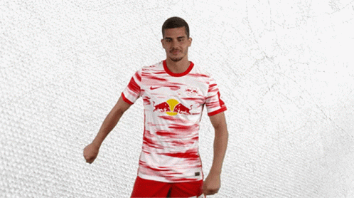 a man wearing a red and white jersey with a bull on it