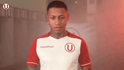 a man wearing a red and white marathon shirt