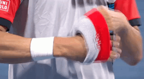 A Man Wearing A Red And White Shirt That Says Uniqlo On The Sleeve GIF