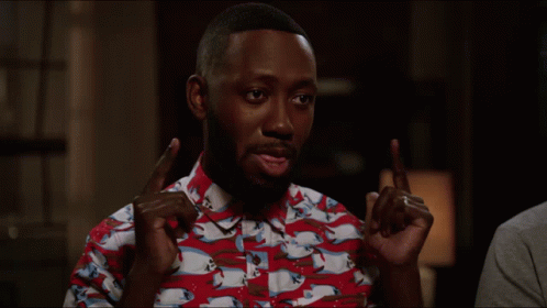A Man Wearing A Red And White Shirt With Horses On It Is Pointing GIF