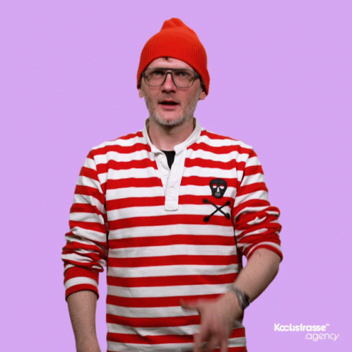 A Man Wearing A Red And White Striped Shirt With A Skull And Crossbones On The Chest GIF