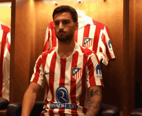 A Man Wearing A Red And White Striped Shirt With The Word Riyadh Air On The Sleeve GIF