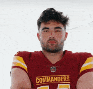 A Man Wearing A Red And Yellow Commanders Jersey GIF