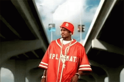A Man Wearing A Red Baseball Jersey With The Word Ipl On It . GIF