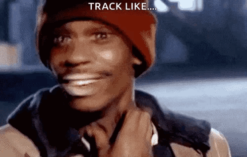 A Man Wearing A Red Beanie And A Jacket Is Smiling And Holding His Neck . GIF