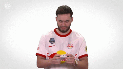 A Man Wearing A Red Bull Jersey Is Clapping GIF