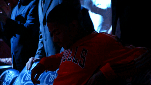 A Man Wearing A Red Bulls Shirt Sits In A Row Of Coca Cola Seats GIF