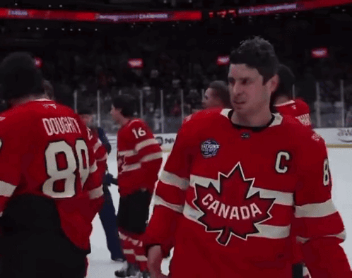 A Man Wearing A Red Canada Jersey Stands On The Ice GIF