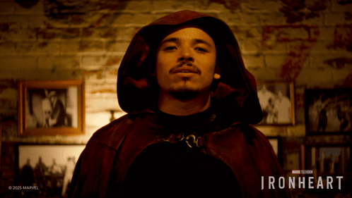 A Man Wearing A Red Cape With The Words Ironheart On The Bottom GIF