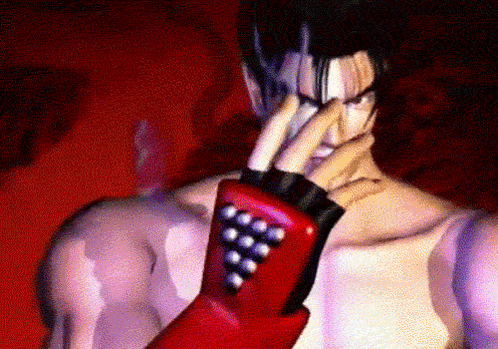 A Man Wearing A Red Glove With A Bunch Of Balls On It GIF