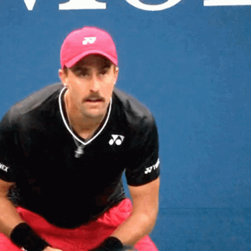 A Man Wearing A Red Hat And A Black Shirt With Yonex Written On The Sleeves GIF