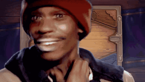 A Man Wearing A Red Hat And A Black Vest Is Smiling GIF