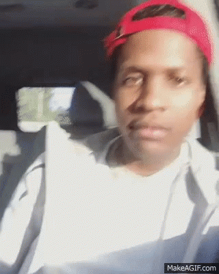A Man Wearing A Red Hat Is Sitting In The Back Seat Of A Car GIF