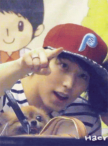a man wearing a red hat with a blue letter p on it