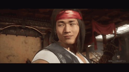 A Man Wearing A Red Headband And A White Shirt Is Standing In A Room .. GIF