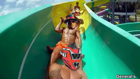 A Man Wearing A Red Helmet Is Sliding Down A Water Slide At General 'S GIF