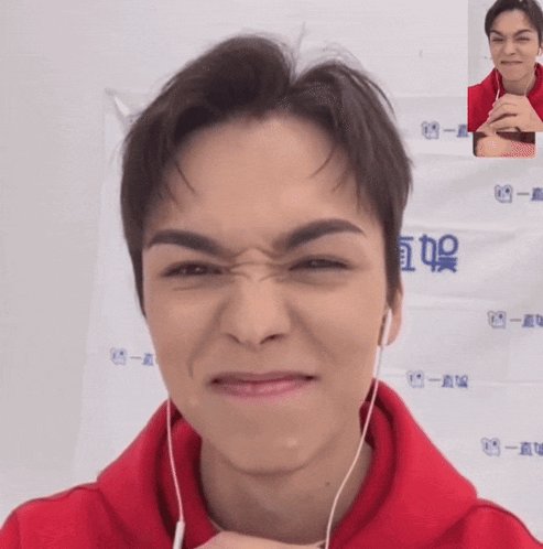 A Man Wearing A Red Hoodie Is Making A Face GIF