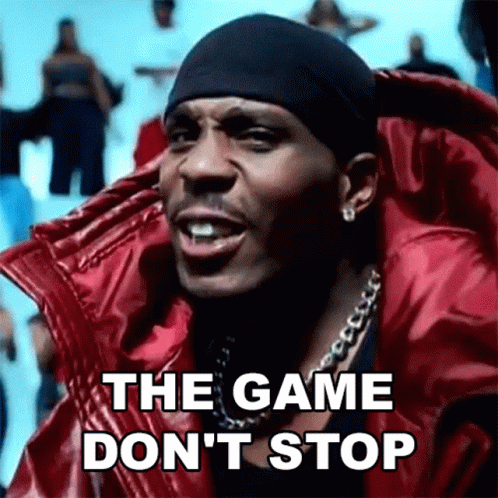 A Man Wearing A Red Jacket And A Black Headband Is Singing The Game Don 'T Stop . GIF