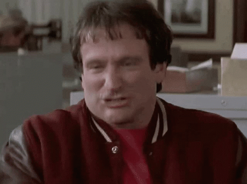 A Man Wearing A Red Jacket And A Red Shirt Is Making A Funny Face GIF