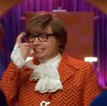 A Man Wearing A Red Jacket And Glasses Is Talking On A Cell Phone GIF