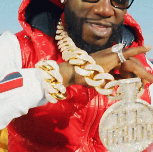 Man In Red Jacket Holding Pendant Saying 11 GIF