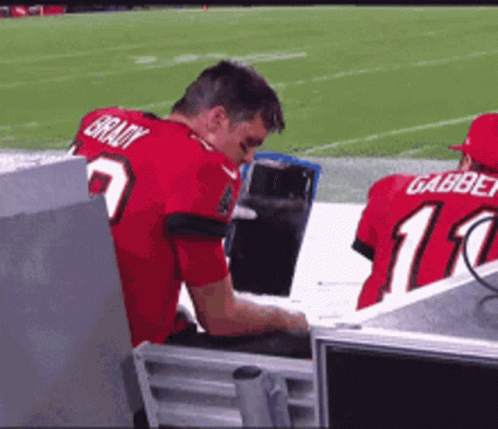 A Man Wearing A Red Jersey That Says Brady On The Back GIF