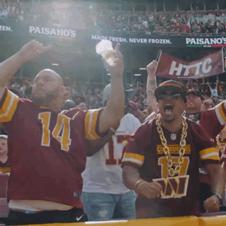 A Man Wearing A Red Jersey With The Number 14 On It Is Cheering GIF
