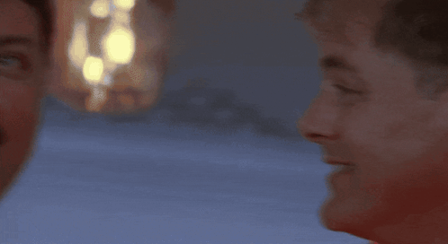 A Man Wearing A Red Life Jacket With A White Stripe On The Bottom GIF